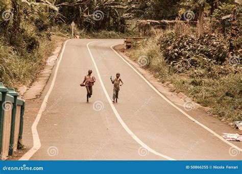Two Young Children Running Barefoot In A Street Editorial Image
