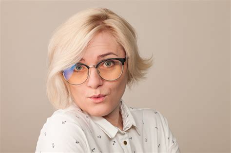 Studio Portrait Of An Attractive 40 Year Old Blonde Woman With Glasses