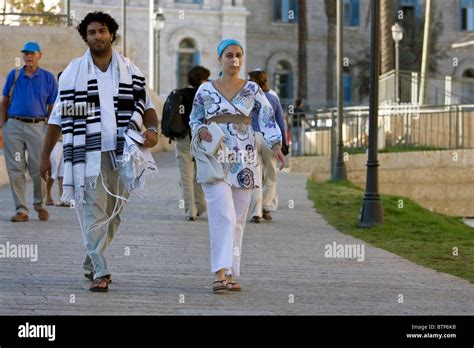 jewish people dressed in traditional religious clothes go to the wailing wall at yom kippur in