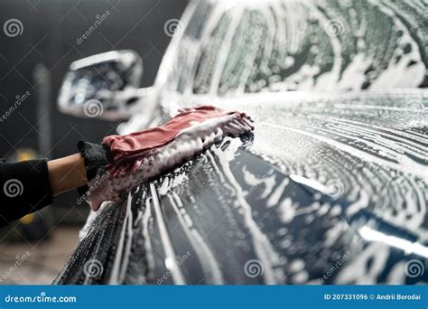 Professional Car Wash Detailing Worker Washes The Vehicle Body With