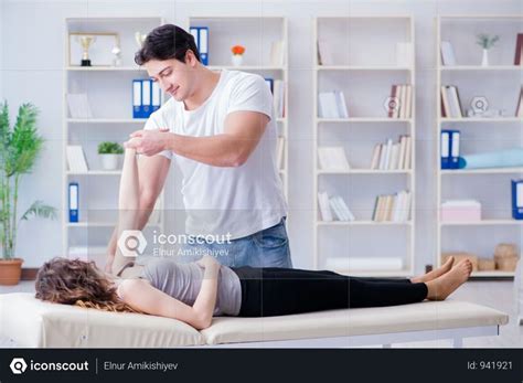 Young Doctor Chiropractor Massaging Female Patient Woman Photo