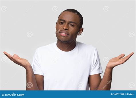 Confused African American Man Shrugging Shoulders Looking At Camera