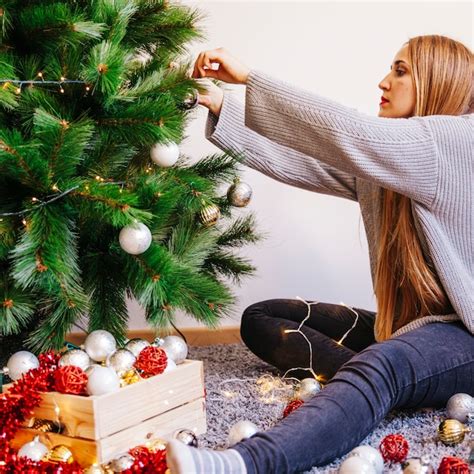 Free Photo Young Woman Decorating Christmas Tree