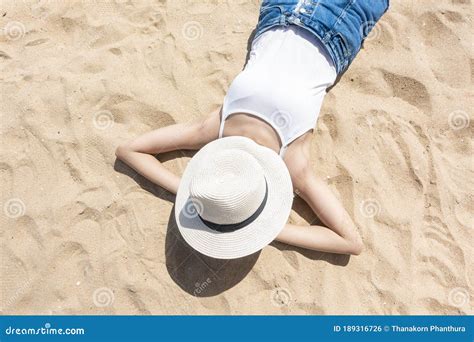 A Woman Is Laying On The Beach Stock Photo Image Of Lifestyle