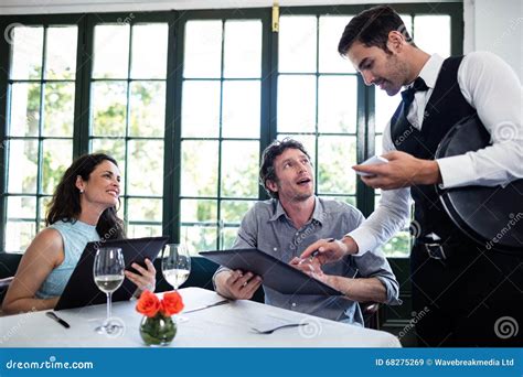 Waiter Taking An Order For A Couple Stock Image Image Of Alcohol