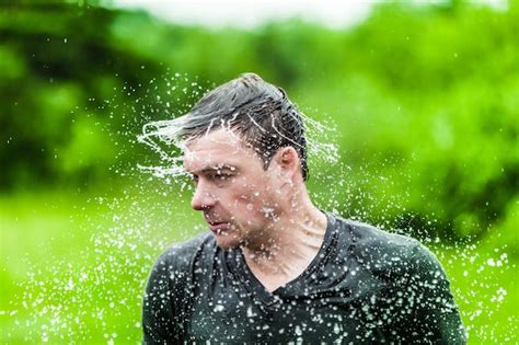 Premium Photo Young Adult Completely Drenched Shaking His Head