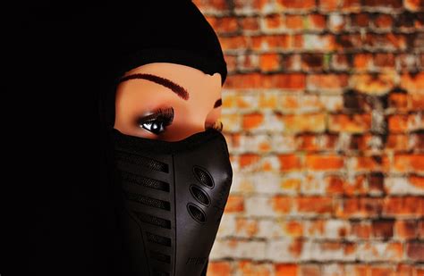 Free Photo Woman Ski Mask Eyes Headwear Cap Doll Brick Wall