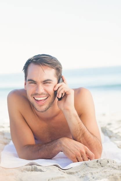 Premium Photo Smiling Handsome Man On The Beach Having A Phone Call