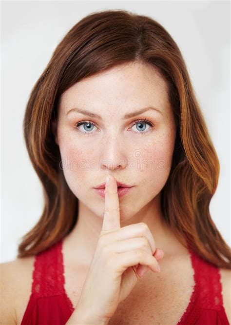 Ssh This Is Out Secret Portrait Of An Attractive Young Woman With Her Finger On Her Lips