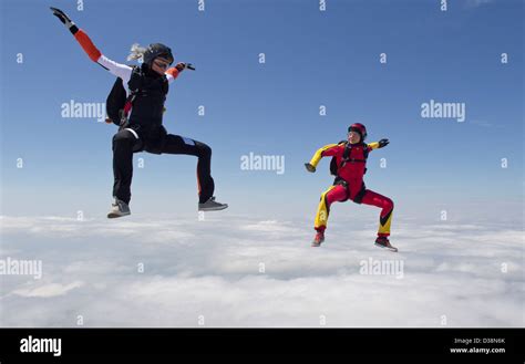 Women Skydiving Over Clouds Stock Photo Alamy