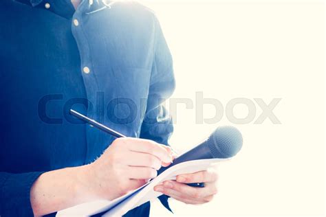 Male Journalist At News Conference Holding Microphone And Taking Notes