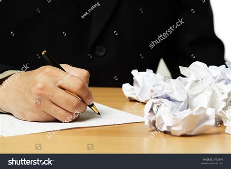 A Businessman Writing On A Piece Of Paper Stock Photo 3553695