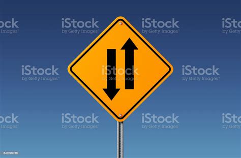 Two Way Road Sign Showing Opposite Directions On Blue Sky Stock Photo