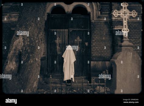 In this eerie Halloween photograph, a ghostly figure stands on the
