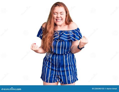 Young Beautiful Redhead Woman Wearing Casual Clothes Very Happy And Excited Doing Winner Gesture