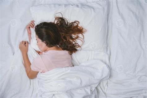 Young Woman Sleeping Well In Bed Hugging Soft White Pillow Teenage