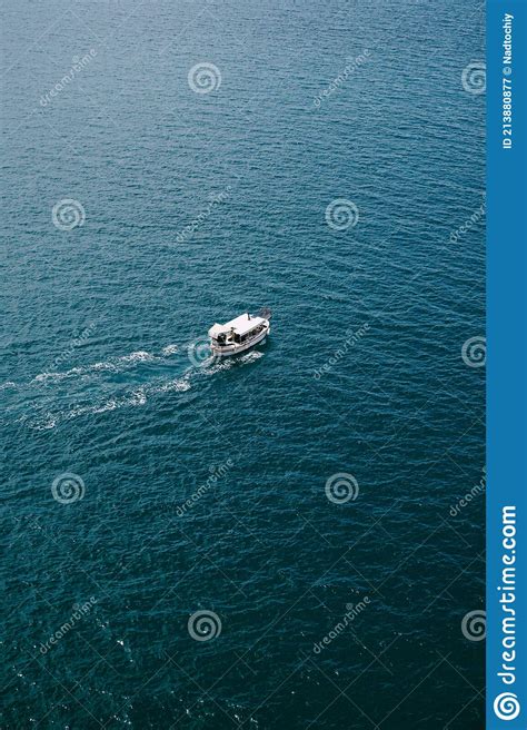 Small Tourist Boat Floats On Water Texture Aerial Frame From