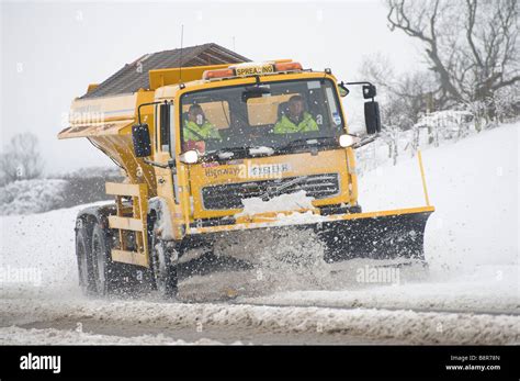Gritter Lorry With Snow Plough Fitted To The Front Clearing The Roads