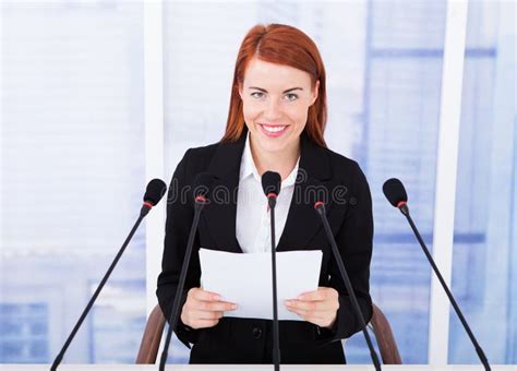 Smiling Businesswoman Giving Speech At Conference Stock Photo Image