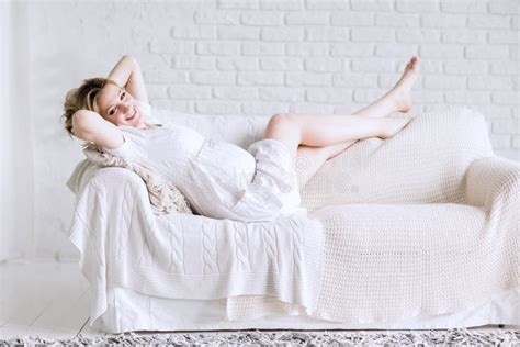Happy Young Pregnant Woman Lying On Sofa In Bright Living Room Stock Image Image Of Indoors
