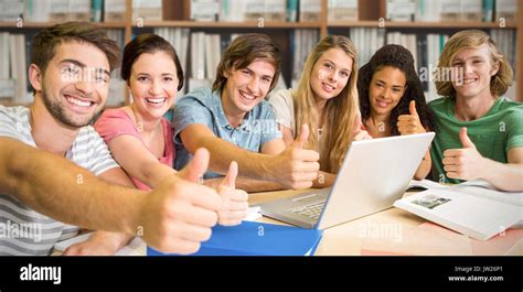 College Students Gesturing Thumbs Up In Library Against Various Multi