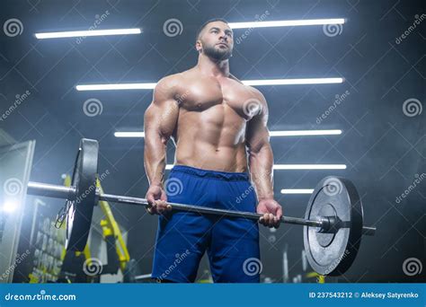 Bottom Up View Of A Muscular Athlete Lifting Heavy Barbell Showing His