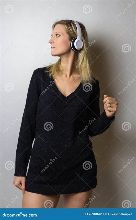 Portrait Of Beauty Young Caucasian Blonde Hair Woman Listen Music On