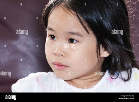 Little Cute Asian Girl Looking Something And Thinking Look Like Absent
