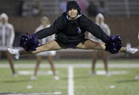 A Cinco Ranch Cheerleader Is Introduced In The Rain Before The Photo