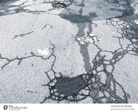 Cracks And Potholes In The Asphalt A Royalty Free Stock Photo From