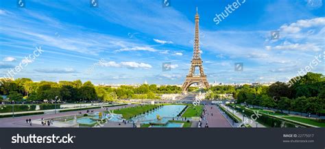 Eiffel Tower Panorama With Cloudy Blue Sky And Surrounding Park Stock
