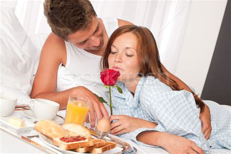 Happy Man And Woman Having Breakfast In Bed Together Stock Photo © Jean