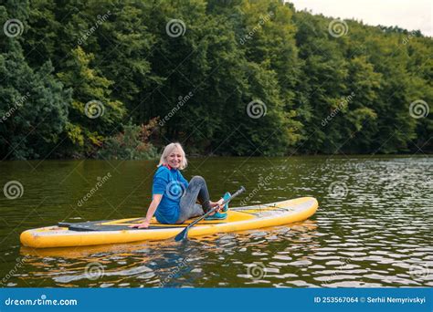 A Woman With An Oar A Trip On A Sap Board A Big River In The Middle