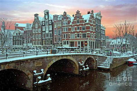 Snowy Amsterdam In The Netherlands In Winter At Sunset Photograph By