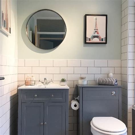 A classic design that is incredibly versatile and creates a timeless look. Bathroom with white metro tiles and grey grout. Mint walls ...