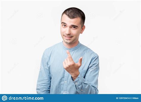 Playful Adult Showing Come Here Gesture With Index Finger And Smiling
