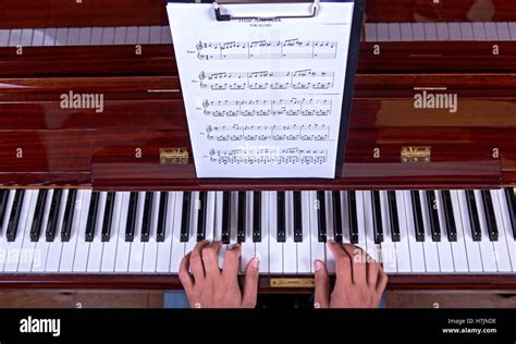 Man playing piano with both hands top view Stock Photo - Alamy