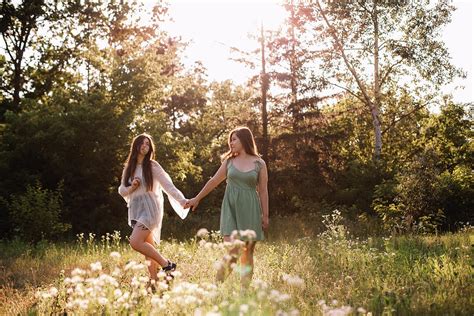Lesbian Couple Holding Hands While Walking In Forest In Summer Photograph By Cavan Images Fine