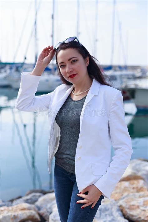 Portrait Of Woman Dressed In Nautical Style In Yacht Marina Stock Image