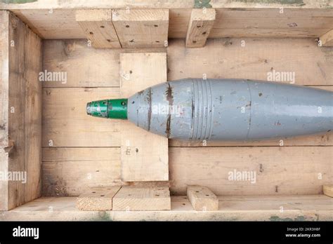120mm Mortar Shell In Army Green Crate Isolated Om White Bacground