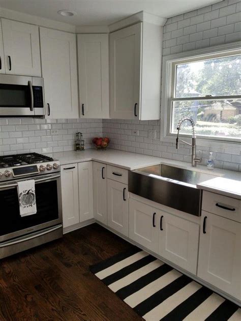Both options are durable, resist kitchen spills and splashes, and are available in plenty of designs and textures. White kitchen cabinets, stainless steel farmhouse sink #KitchenCountertopsLaminate (With images ...