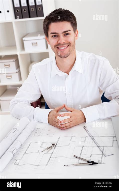 Portrait Smiling Young Man Working Blueprint Desk Office Hi Res Stock