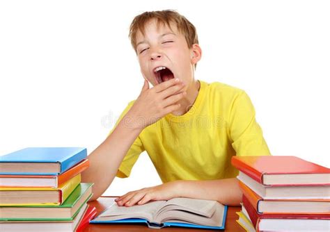 Tired Schoolboy Yawning Tired Kid Yawning At The School Desk With A