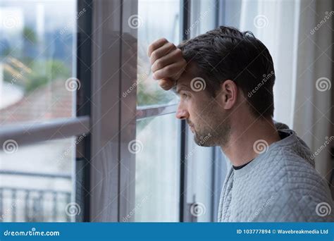 Thoughtful Man Looking Through Window Stock Photo Image Of Domestic