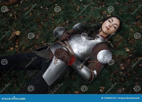A Beautiful Warrior Girl Wearing Chainmail And Armor Lying On The
