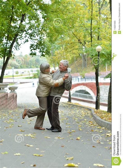 Beautiful Caucasian Senior Couple Dancing In The Park Stock Image