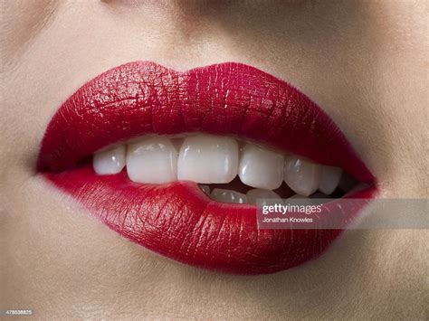 Female With Red Lipstick Biting Lips Close Up Bildbanksbilder Getty
