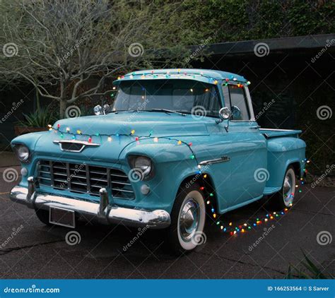 Classic Blue Pickup Truck Strung With Christmas Lights Stock Photo