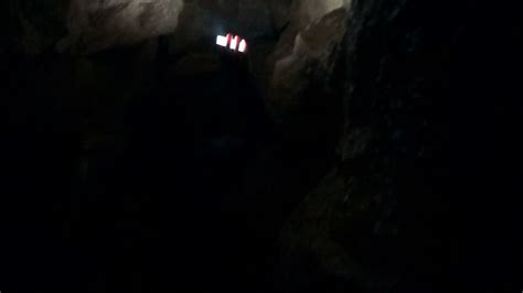 Man Explores Cave With Light In Narrow Cave Stock Footage Sbv 301807975