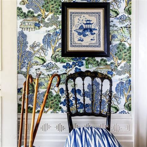A Wall Covered In Thibaut Asian Scenic Wallpaper Lined With A Greek Key